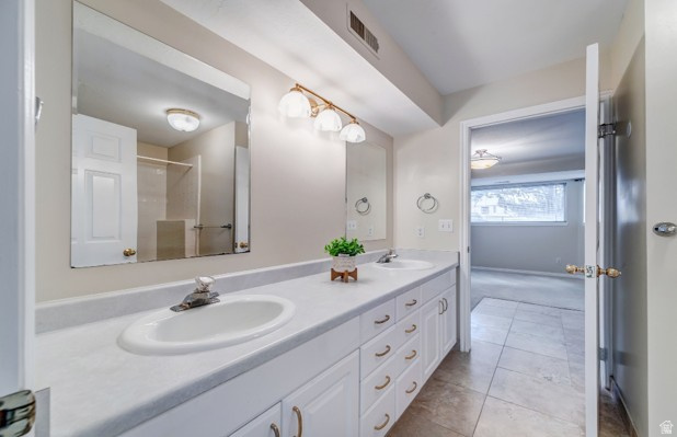 1273 Grayson Court Sandy, UT 84094 - Photo 21 of 27 Double vanity with white cabinetry, dual integrated sinks, and brushed nickel faucets