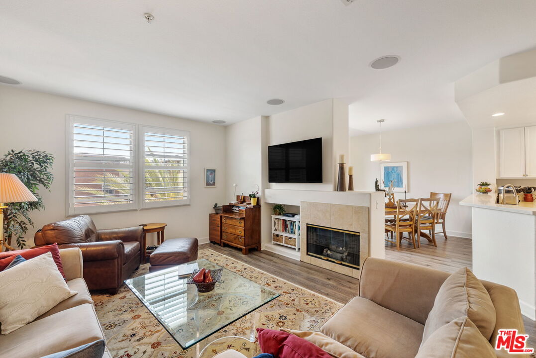 12963 West Runway Road, Unit 408 Playa Vista, CA 90094 - Photo 1 of 44 a living room with furniture fireplace and a flat screen tv