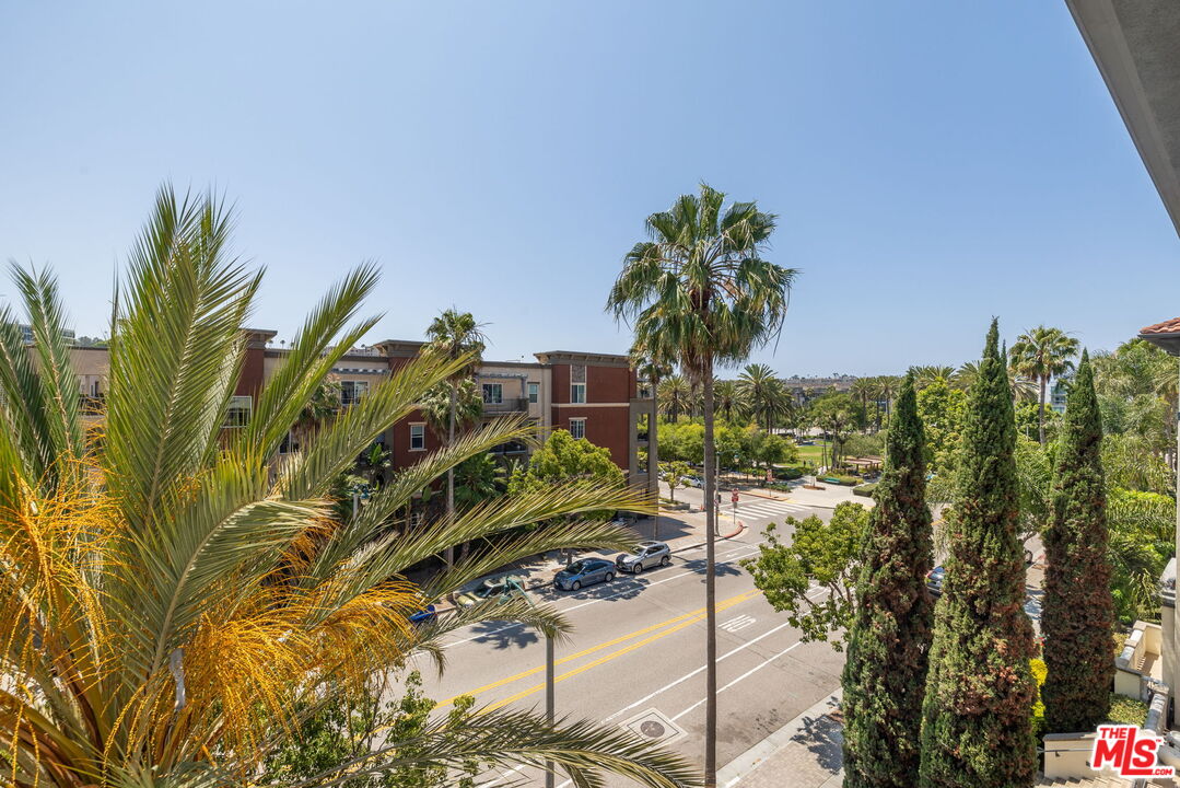 12963 West Runway Road, Unit 408 Playa Vista, CA 90094 - Photo 11 of 44 a view of a yard with plants and palm trees