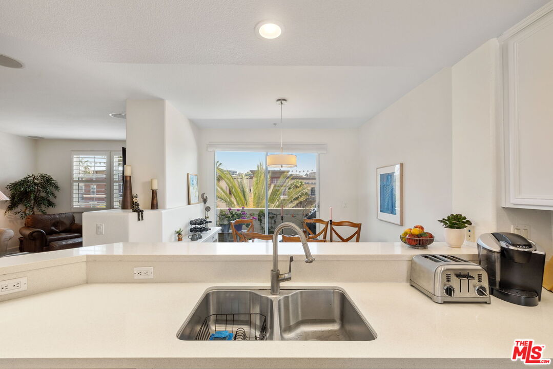 12963 West Runway Road, Unit 408 Playa Vista, CA 90094 - Photo 17 of 44 a kitchen with a sink and a refrigerator