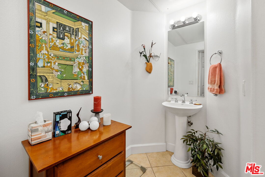 12963 West Runway Road, Unit 408 Playa Vista, CA 90094 - Photo 18 of 44 a bathroom with a sink mirror and vanity