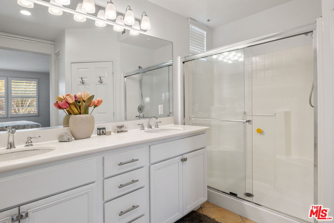12963 West Runway Road, Unit 408 Playa Vista, CA 90094 - Photo 21 of 44 a bathroom with a double vanity sink mirror and shower