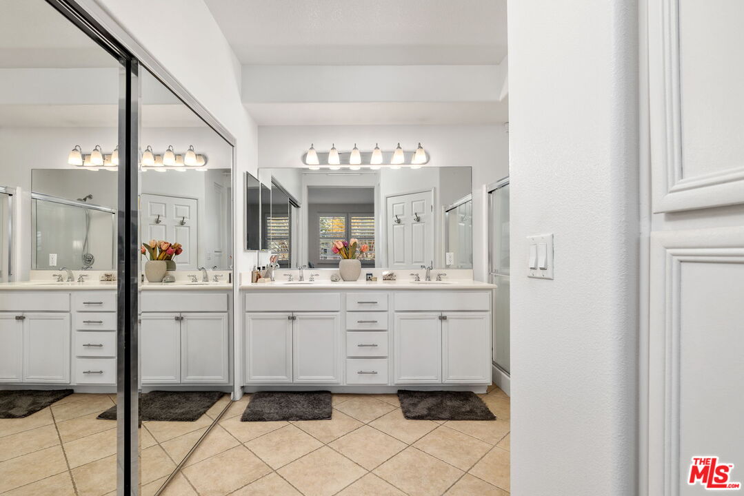 12963 West Runway Road, Unit 408 Playa Vista, CA 90094 - Photo 22 of 44 a bathroom with a sink vanity and a mirror