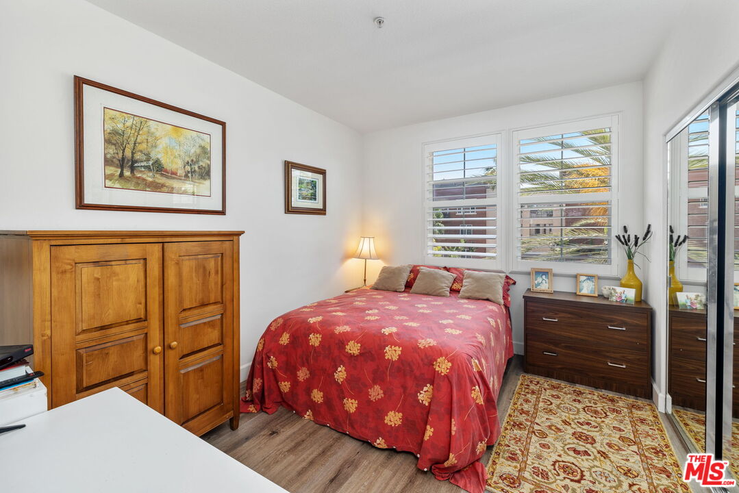12963 West Runway Road, Unit 408 Playa Vista, CA 90094 - Photo 23 of 44 a bedroom with a bed and wooden floor