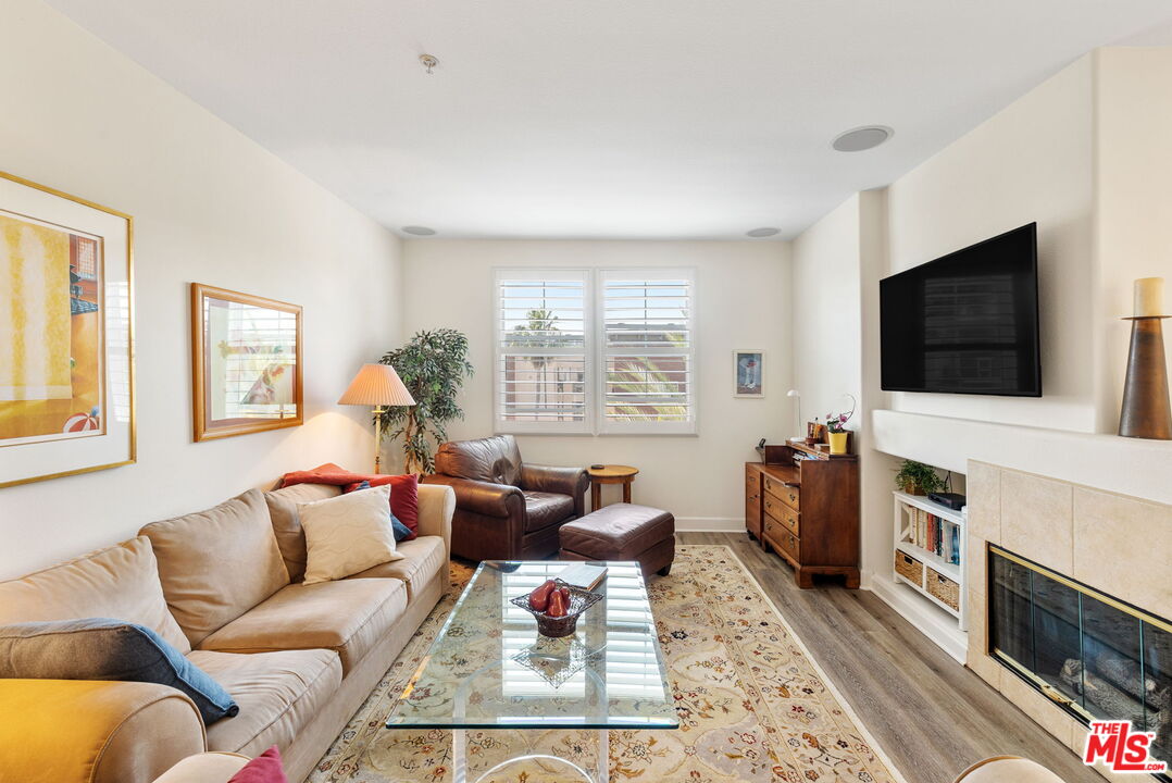 12963 West Runway Road, Unit 408 Playa Vista, CA 90094 - Photo 5 of 44 a living room with furniture and a flat screen tv
