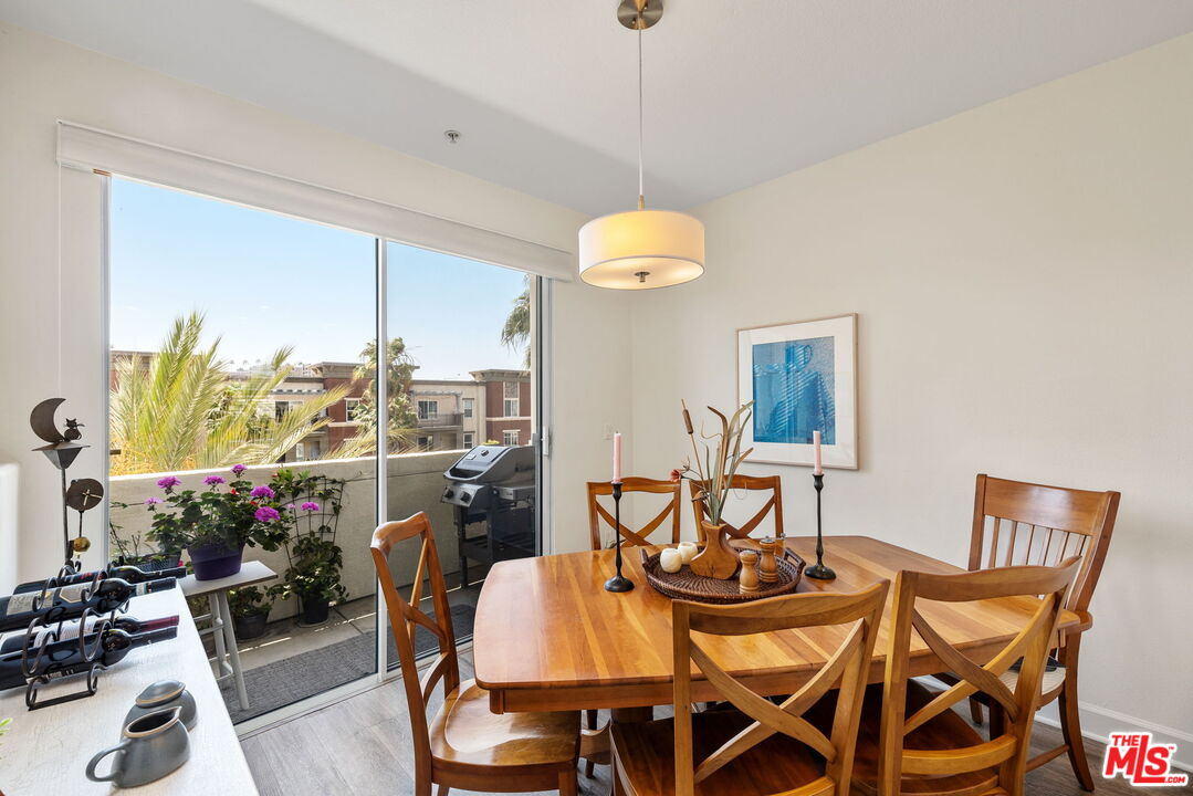 12963 West Runway Road, Unit 408 Playa Vista, CA 90094 - Photo 9 of 44 a view of a dining room with furniture and a chandelier
