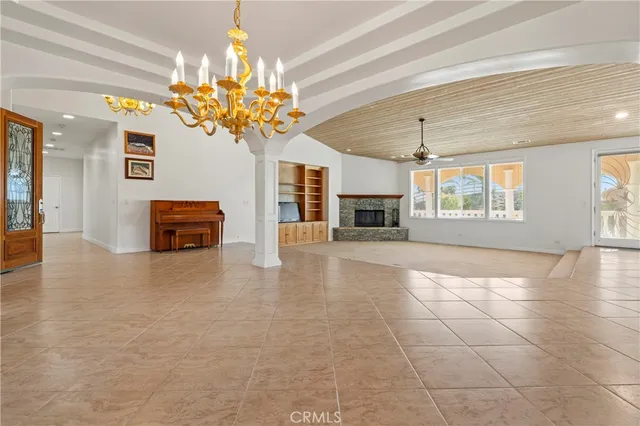 a view of a livingroom with fireplace and window