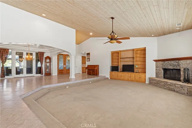 a view of empty room with fireplace and window