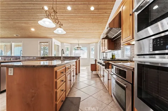 a kitchen with stainless steel appliances granite countertop a sink and cabinets