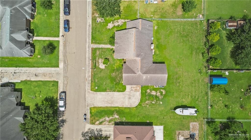 402 Mockingbird Lane Edcouch, TX 78538 - Photo 24 of 25 Expansive lot featuring a main residence with an L-shaped footprint, a substantial grassed yard, and a concrete driveway