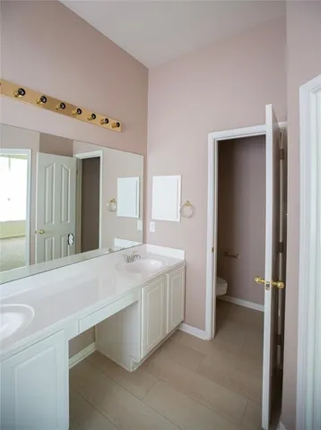a view of a bathroom with a sink and mirror