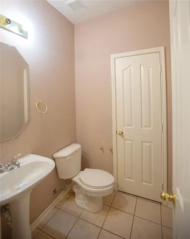 a white toilet sitting next to a bathroom sink