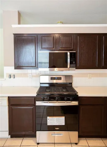 a kitchen with a stove and a microwave