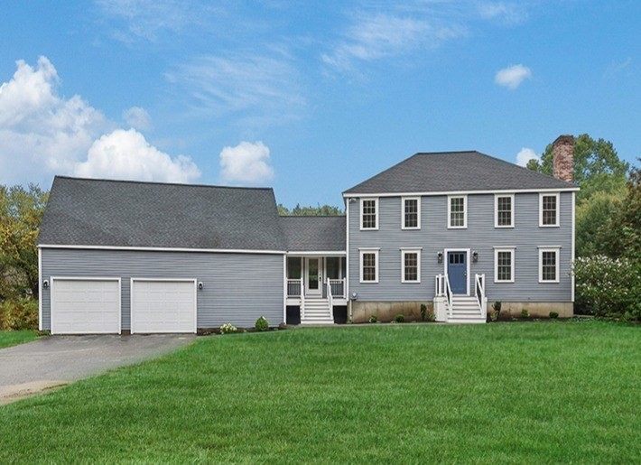 94 Hudson Road Stow, MA 01775 - Photo 1 of 30 a front view of a house with a yard and garage