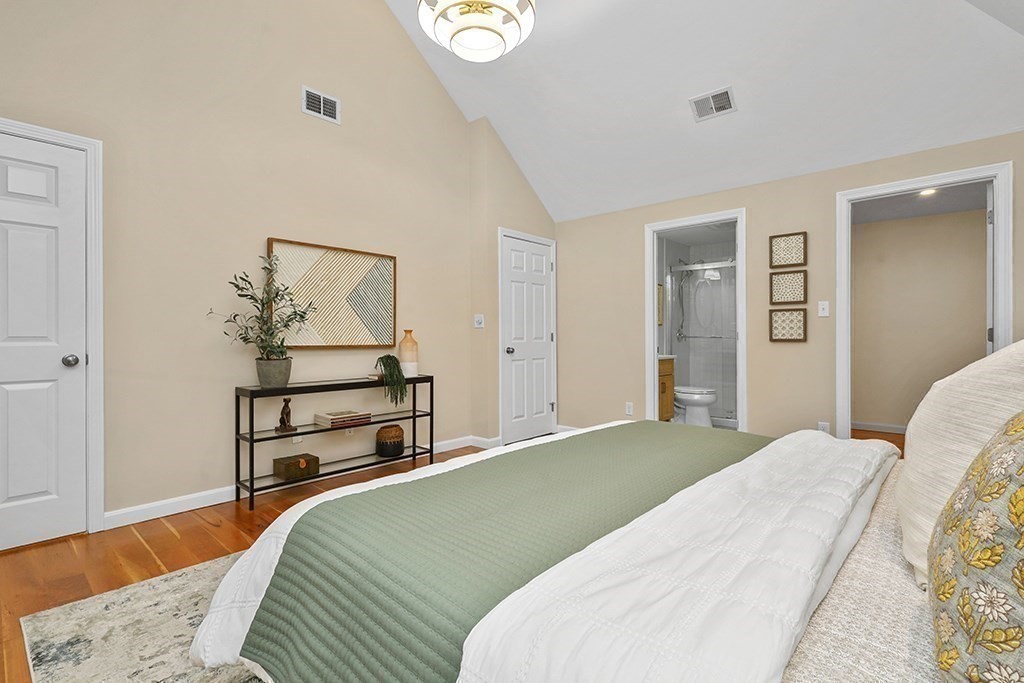 94 Hudson Road Stow, MA 01775 - Photo 20 of 30 a bedroom with a bed and wooden floor