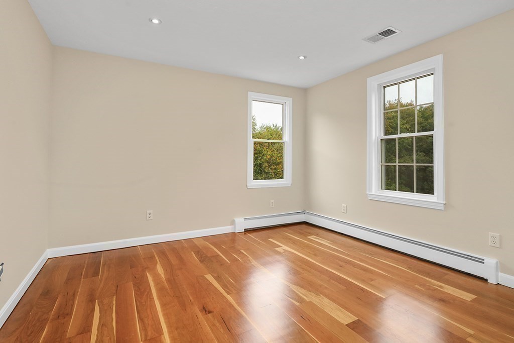 94 Hudson Road Stow, MA 01775 - Photo 22 of 30 a view of an empty room with wooden floor and a window