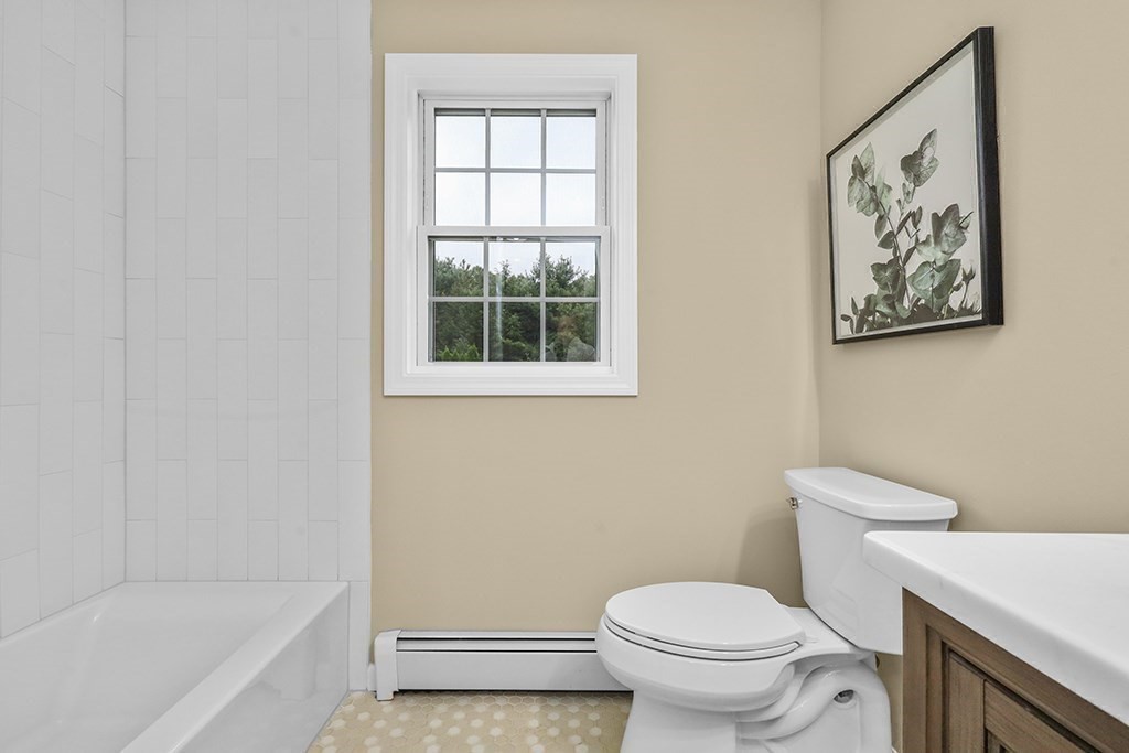 94 Hudson Road Stow, MA 01775 - Photo 24 of 30 a white toilet sitting next to a bath tub