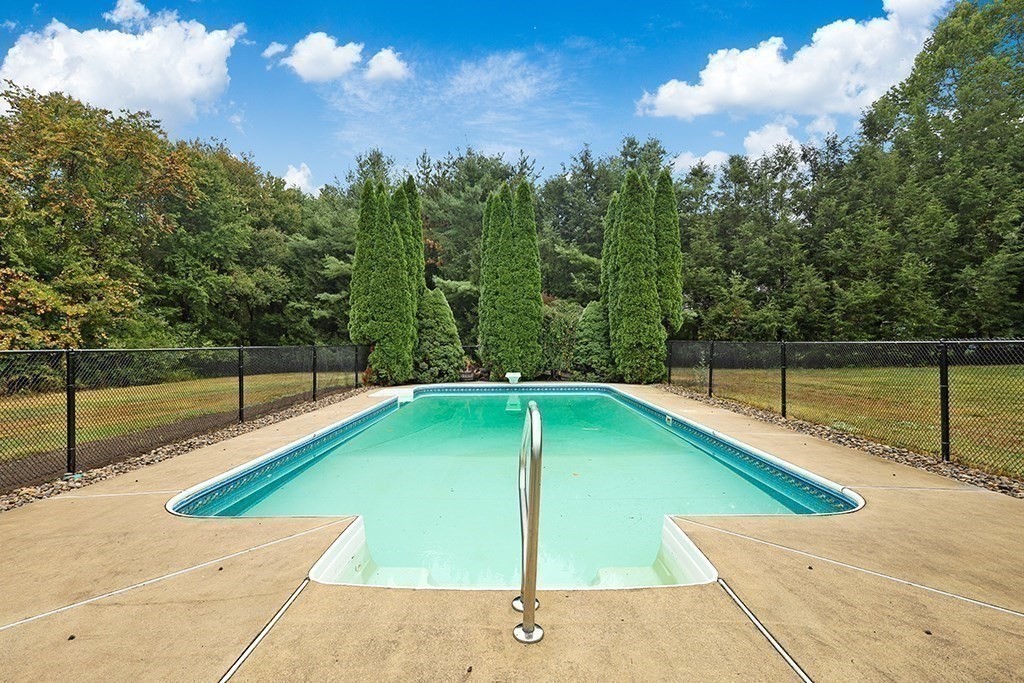 94 Hudson Road Stow, MA 01775 - Photo 29 of 30 a view of a swimming pool with a yard