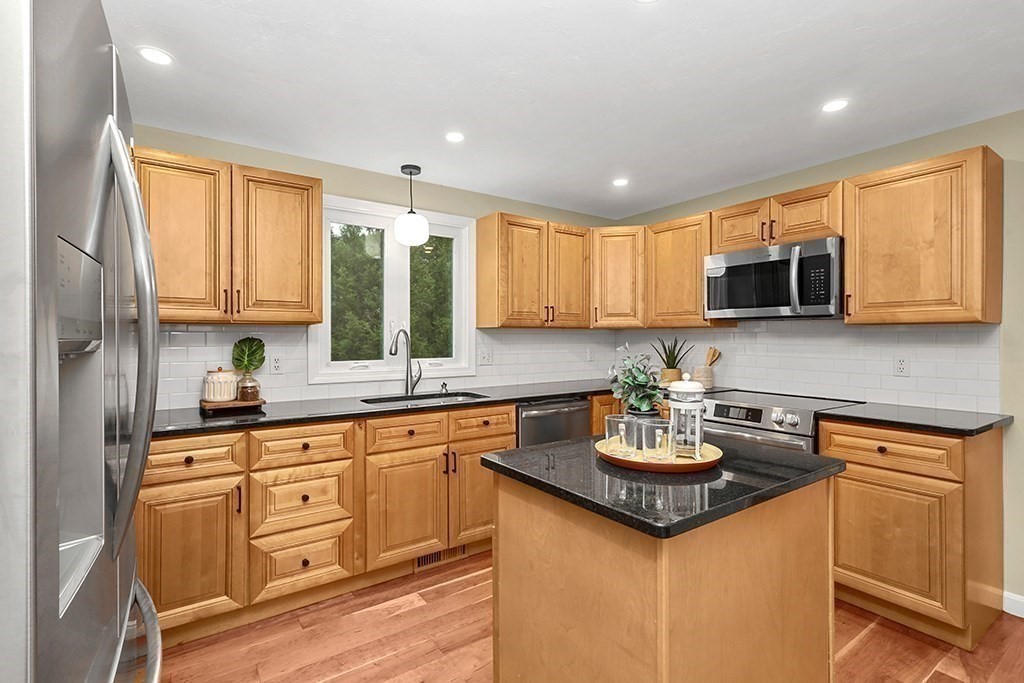 94 Hudson Road Stow, MA 01775 - Photo 9 of 30 a kitchen with a sink stove and microwave