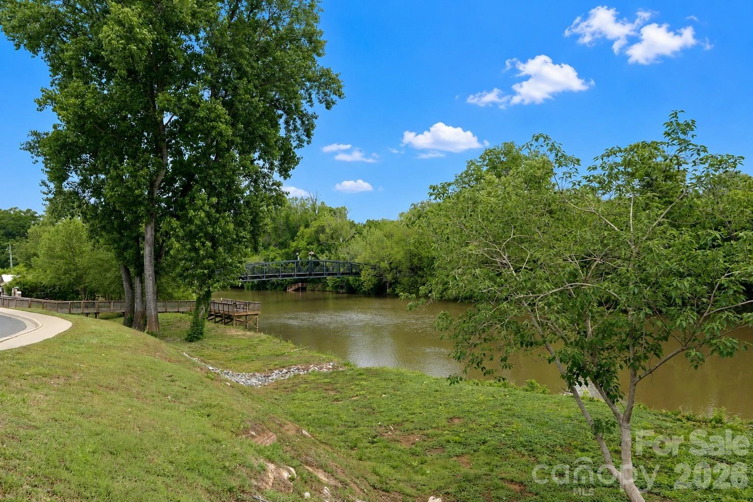 104 Meyers Ridge Road Cramerton, NC 28032 - Photo 15 of 36 a view of a lake with a house in the background