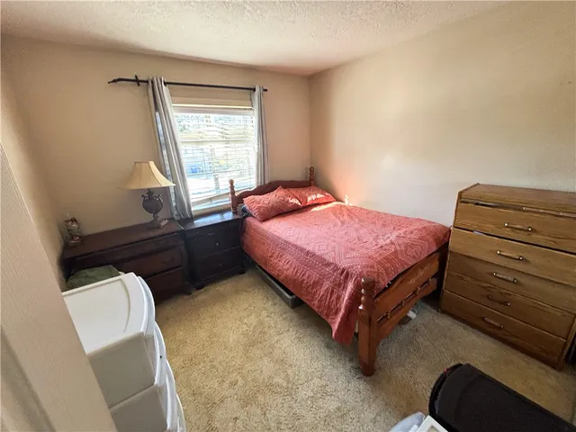 a bedroom with a bed and a flat tv screen