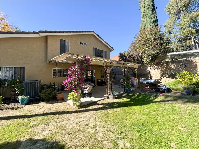 an outdoor sitting area with furniture and garden view