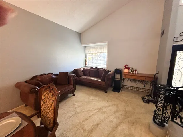 a living room with furniture a flat screen tv and a window