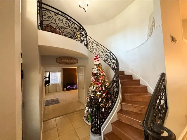 a view of a hallway with wooden floor and stairs