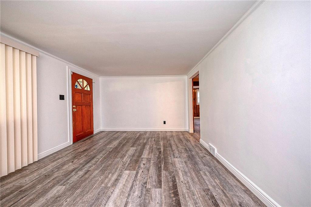 531 Laughlin Avenue Pittsburgh, PA 15210 - Photo 5 of 35 a view of an empty room with wooden floor and a window