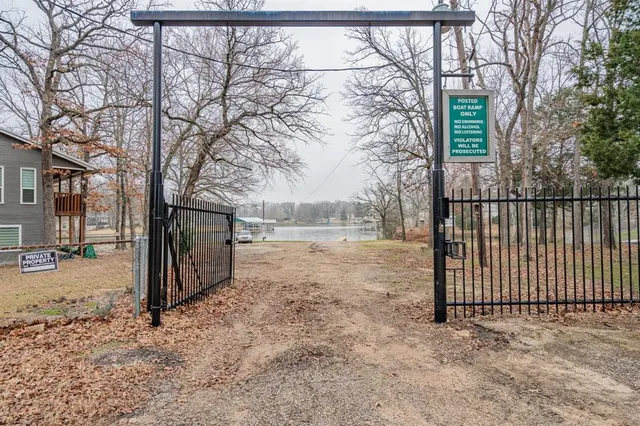 a view of a yard with wooden fence