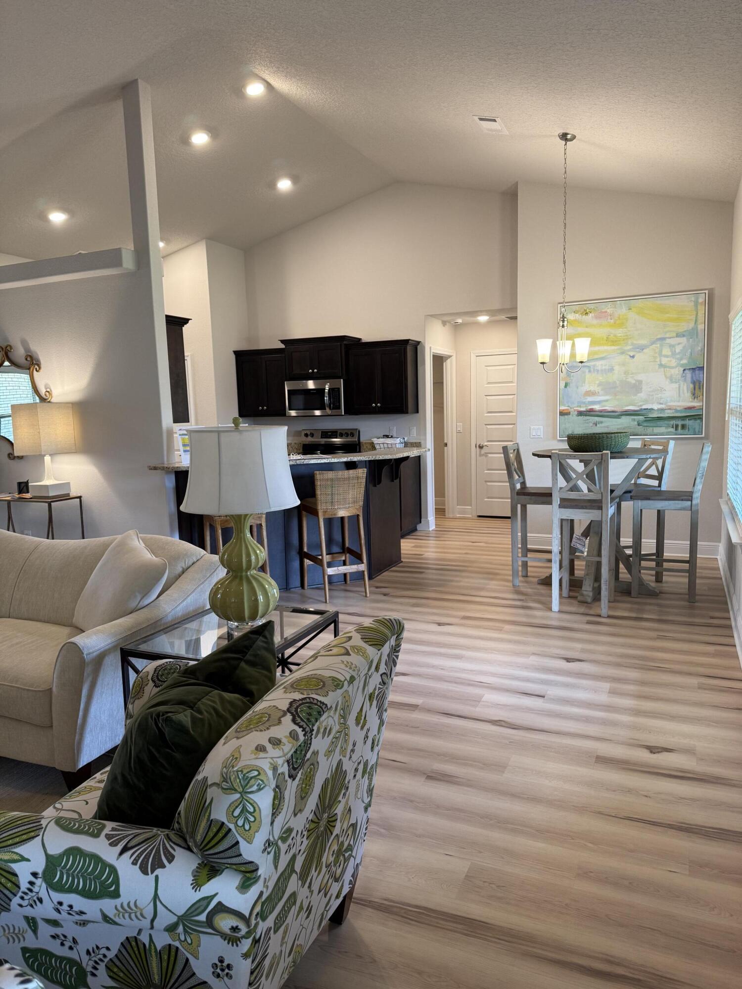 5825 Crestlake Drive Crestview, FL 32536 - Photo 16 of 29 a living room with furniture and a wooden floor