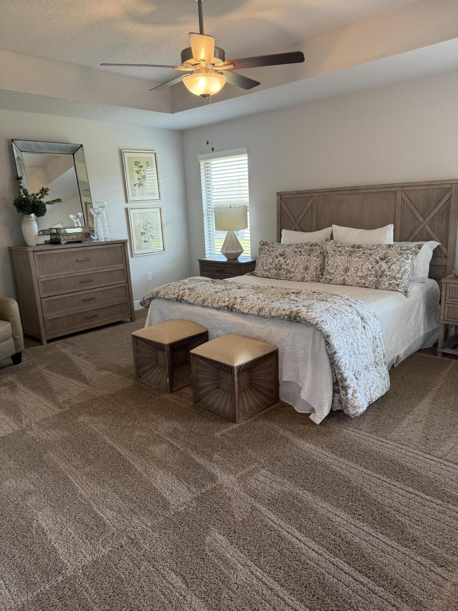 5825 Crestlake Drive Crestview, FL 32536 - Photo 20 of 29 a spacious bedroom with a bed and a chandelier