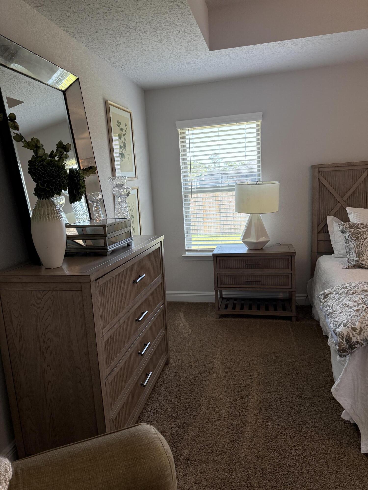 5825 Crestlake Drive Crestview, FL 32536 - Photo 22 of 29 a bedroom with a bed and wooden floor