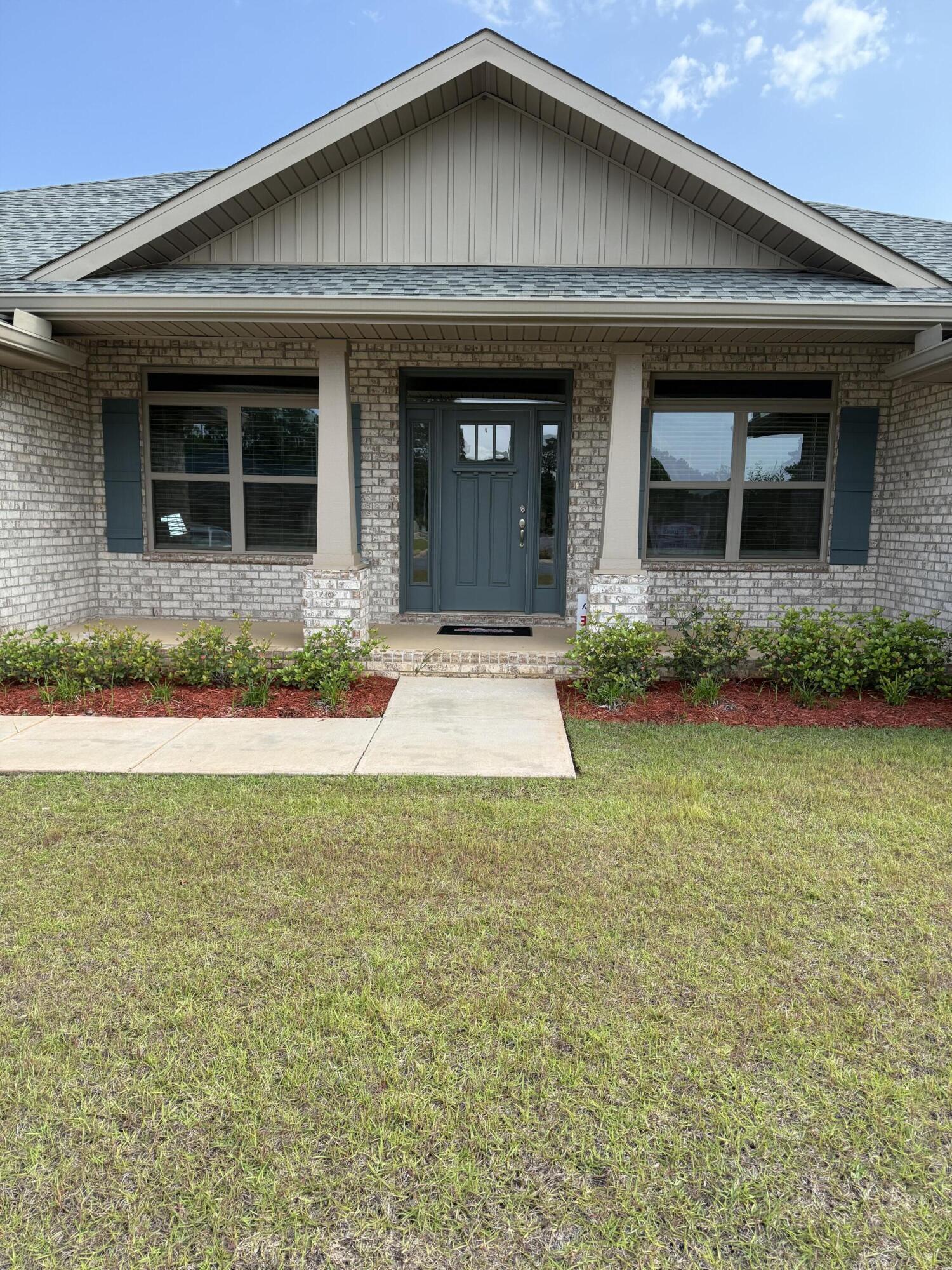 5825 Crestlake Drive Crestview, FL 32536 - Photo 3 of 29 a front view of a house with a yard