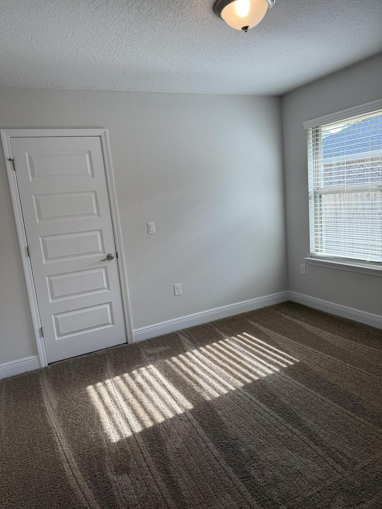 5825 Crestlake Drive Crestview, FL 32536 - Photo 9 of 29 wooden floor in an empty room with a window