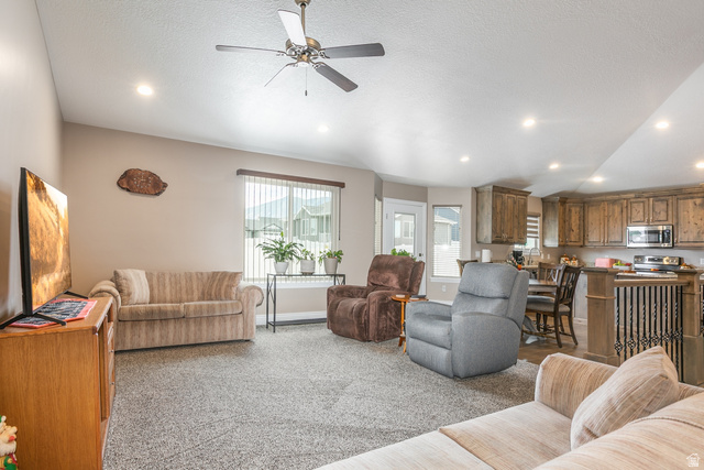 1228 North Providence Way Tooele, UT 84074 - Photo 4 of 28 Open-concept living space featuring recessed lighting, a ceiling fan, and carpet flooring