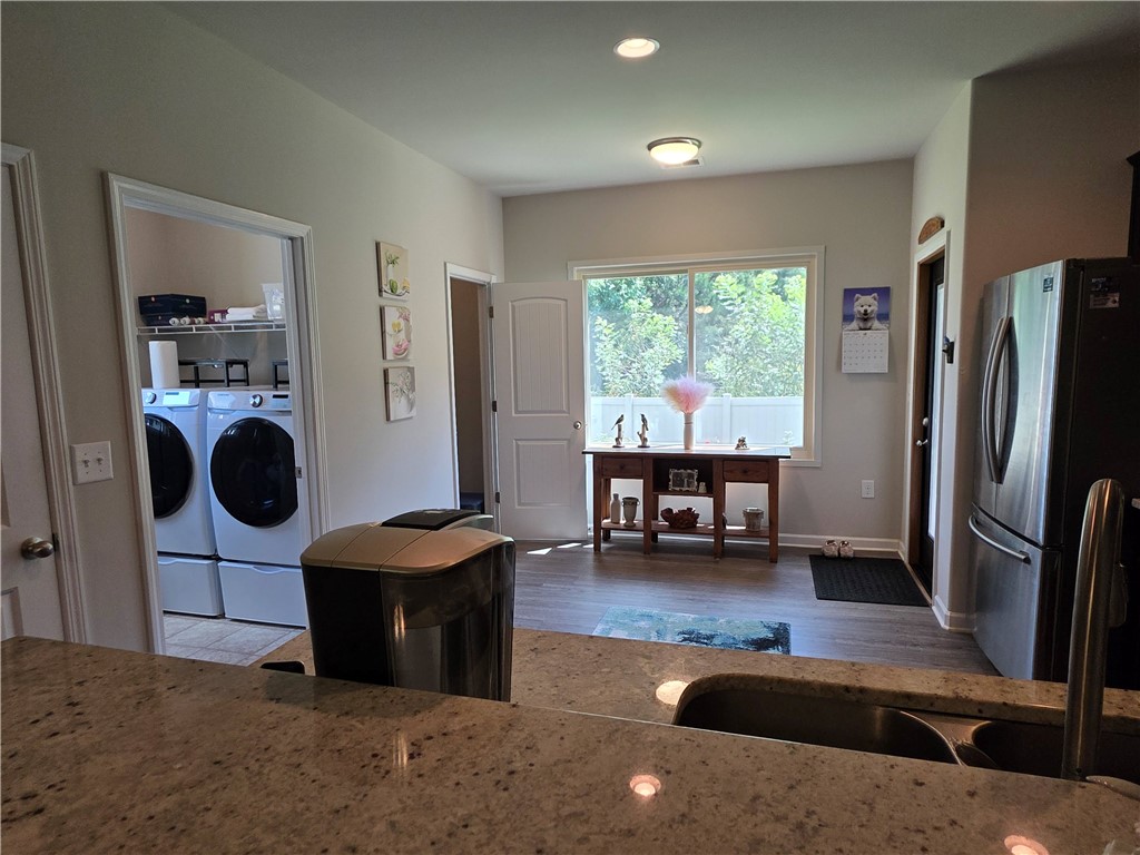 3 Cringle Lane Anderson, SC 29625 - Photo 7 of 26 Granite countertops and stainless steel appliances elevate this functional kitchen and laundry area.