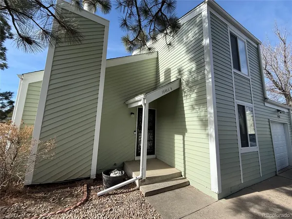 a view of a house with a door and wooden walls