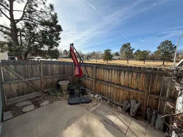 a view of a terrace with a wooden fence