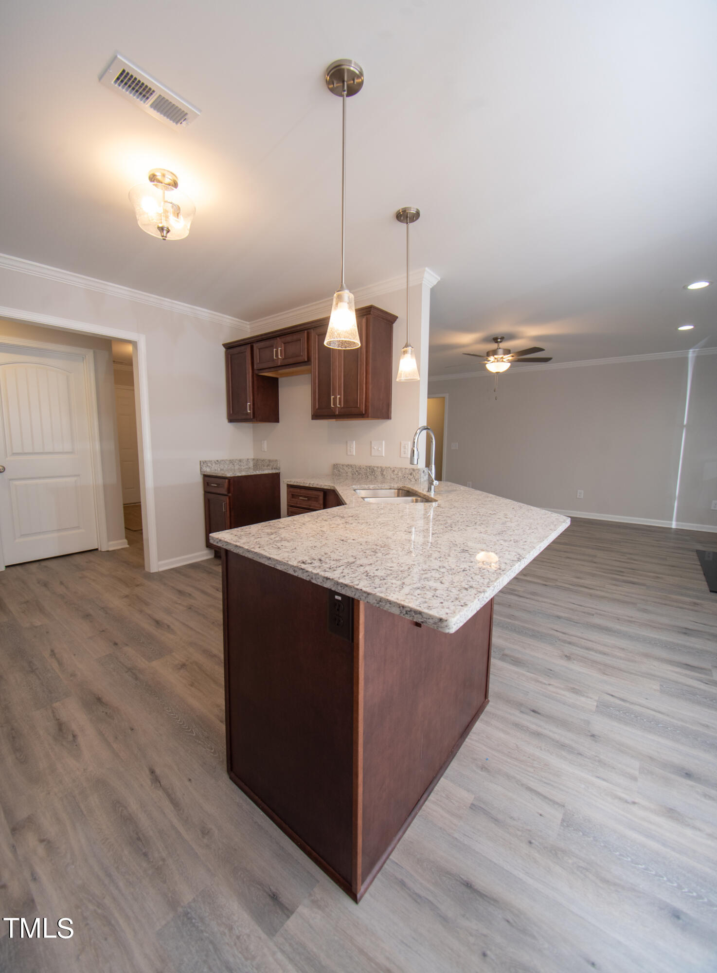 243 Waters Edge Drive Erwin, NC 28339 - Photo 12 of 53 a kitchen with stainless steel appliances granite countertop a sink and a wooden floor