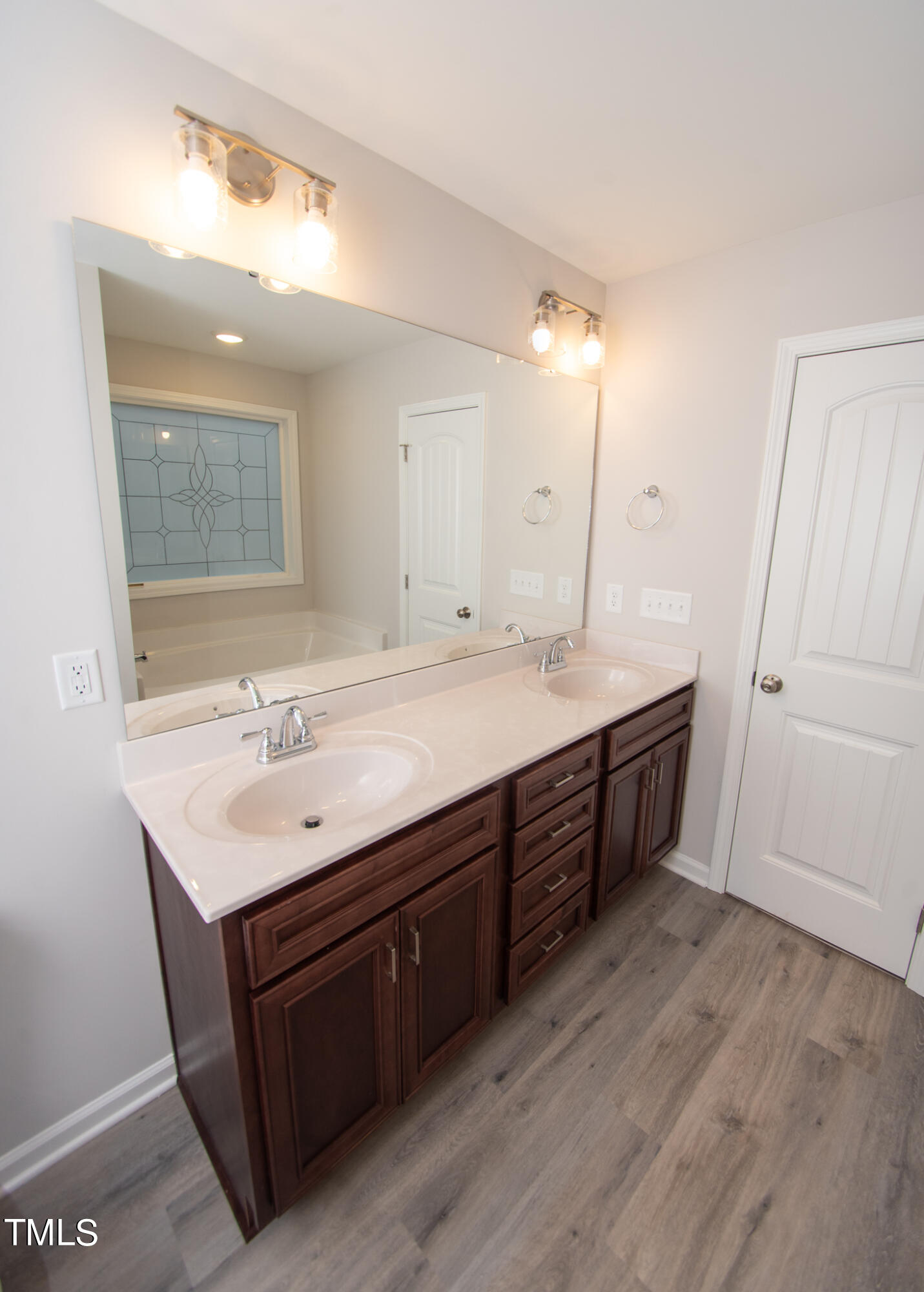 243 Waters Edge Drive Erwin, NC 28339 - Photo 22 of 53 a bathroom with a sink double vanity and a mirror
