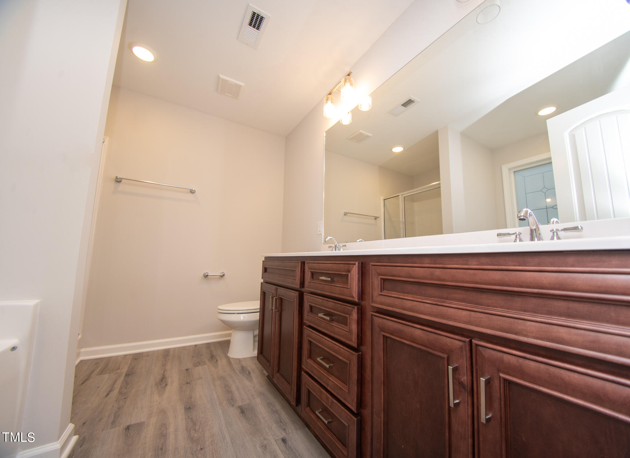243 Waters Edge Drive Erwin, NC 28339 - Photo 23 of 53 a bathroom with a granite countertop sink a toilet and a mirror