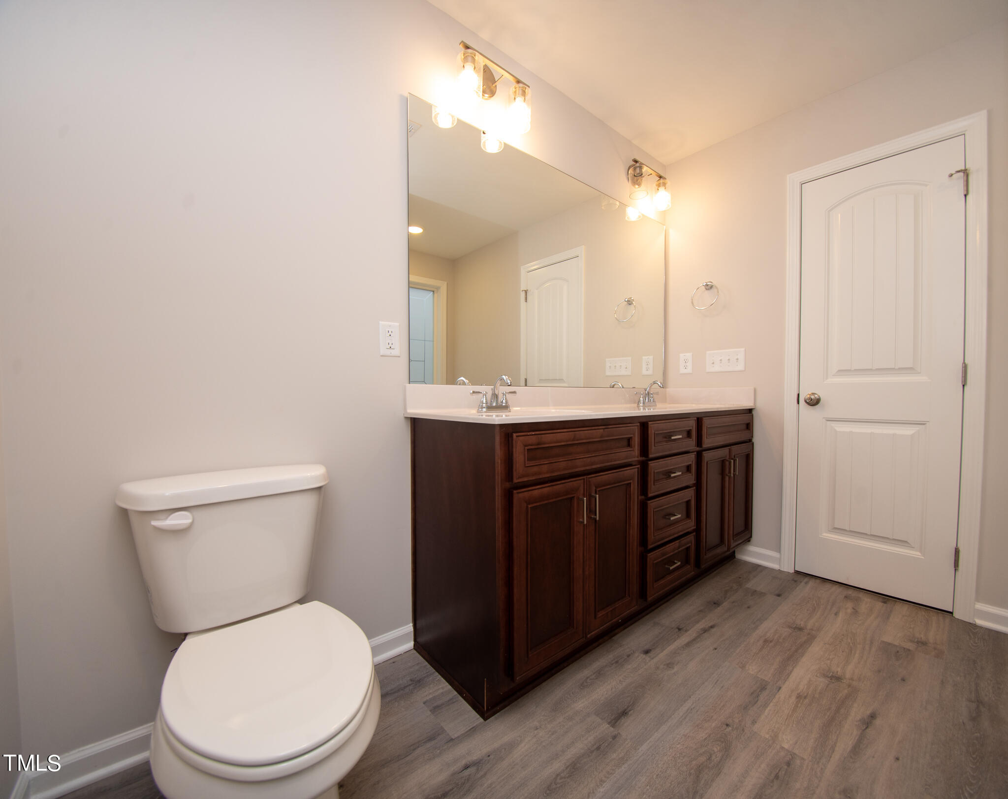 243 Waters Edge Drive Erwin, NC 28339 - Photo 24 of 53 a bathroom with a toilet a sink and mirror