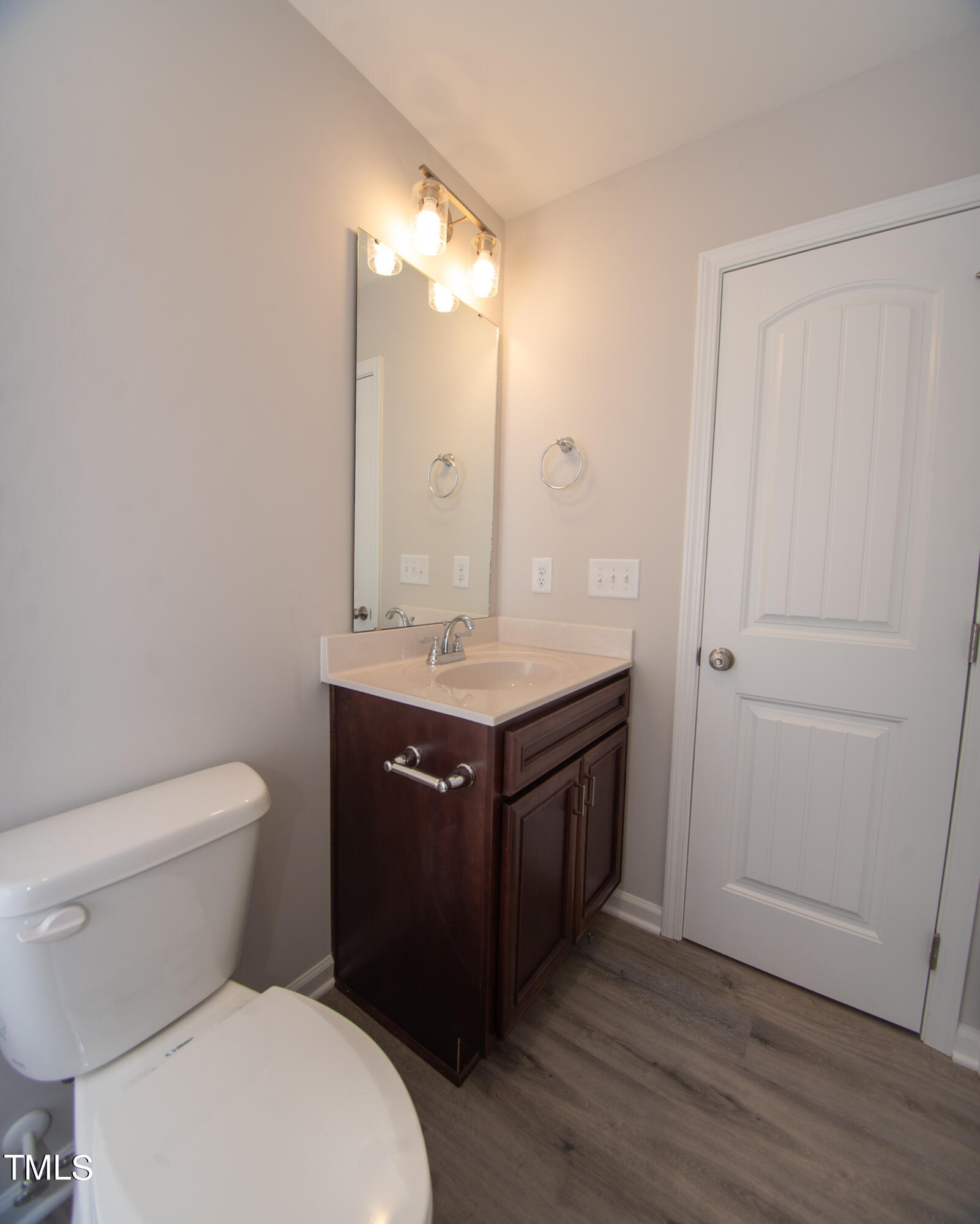 243 Waters Edge Drive Erwin, NC 28339 - Photo 38 of 53 a bathroom with a granite countertop toilet sink and mirror