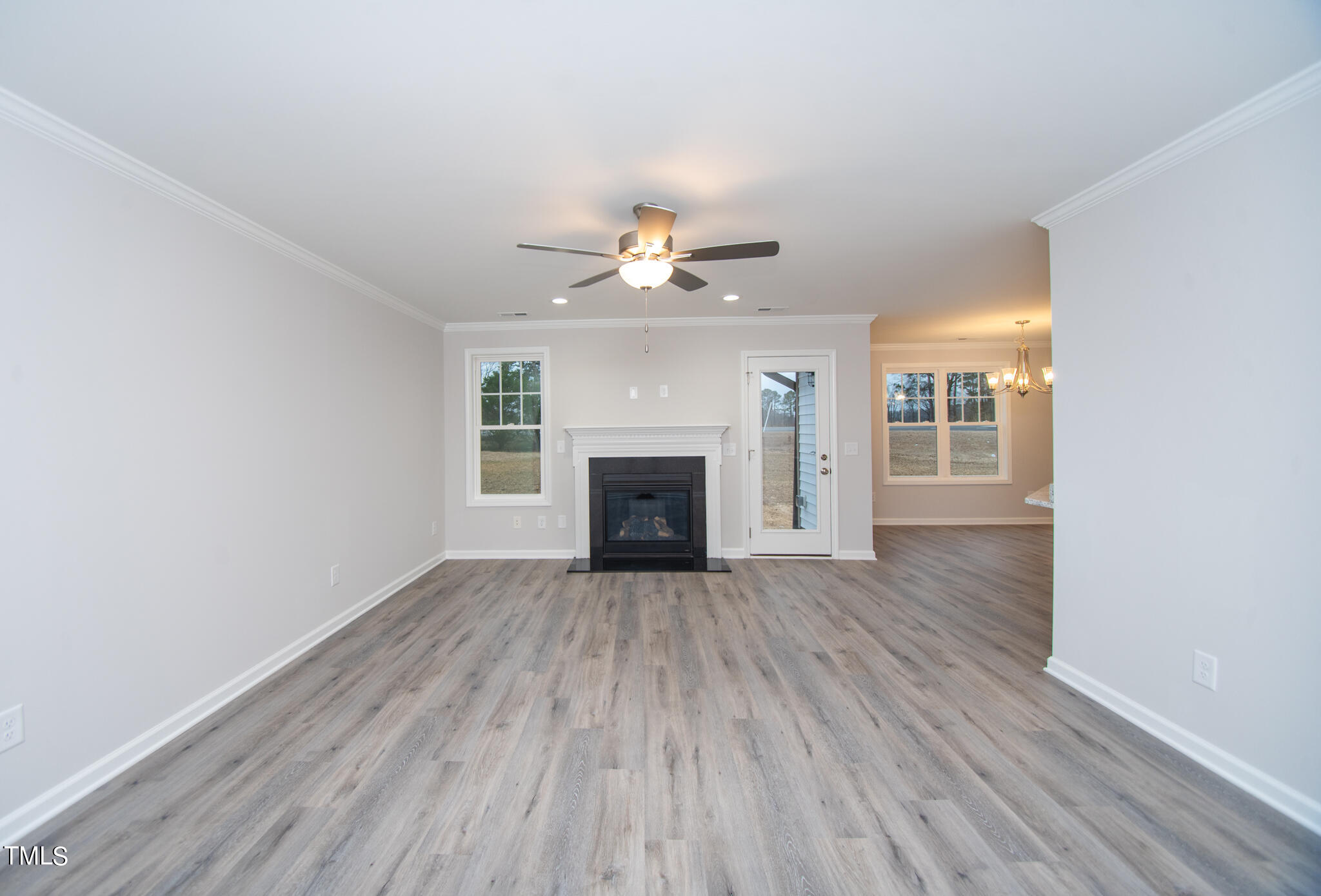 243 Waters Edge Drive Erwin, NC 28339 - Photo 4 of 53 a view of an empty room with wooden floor fireplace and a window