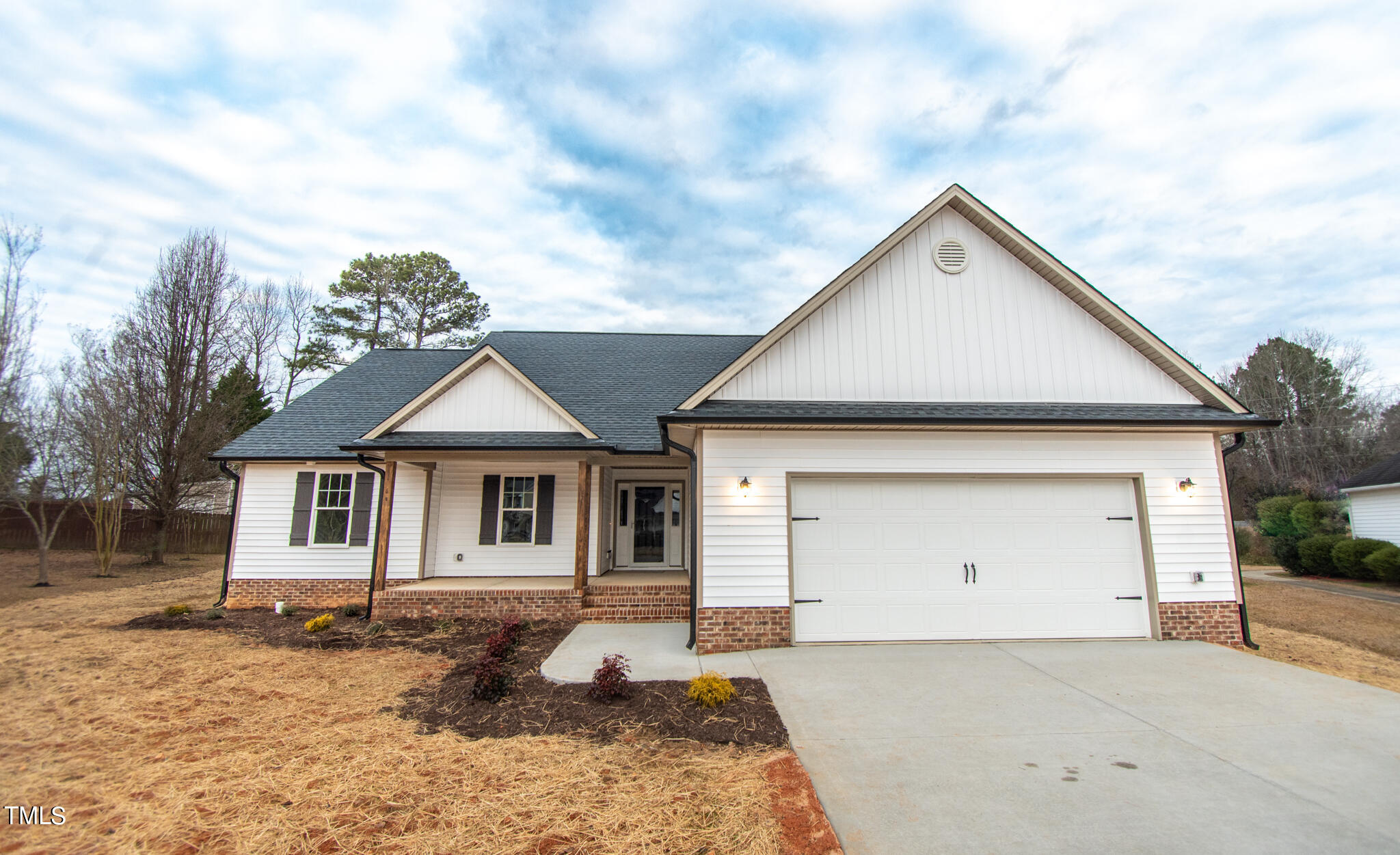 243 Waters Edge Drive Erwin, NC 28339 - Photo 52 of 53 a view of a white house with a yard and garage