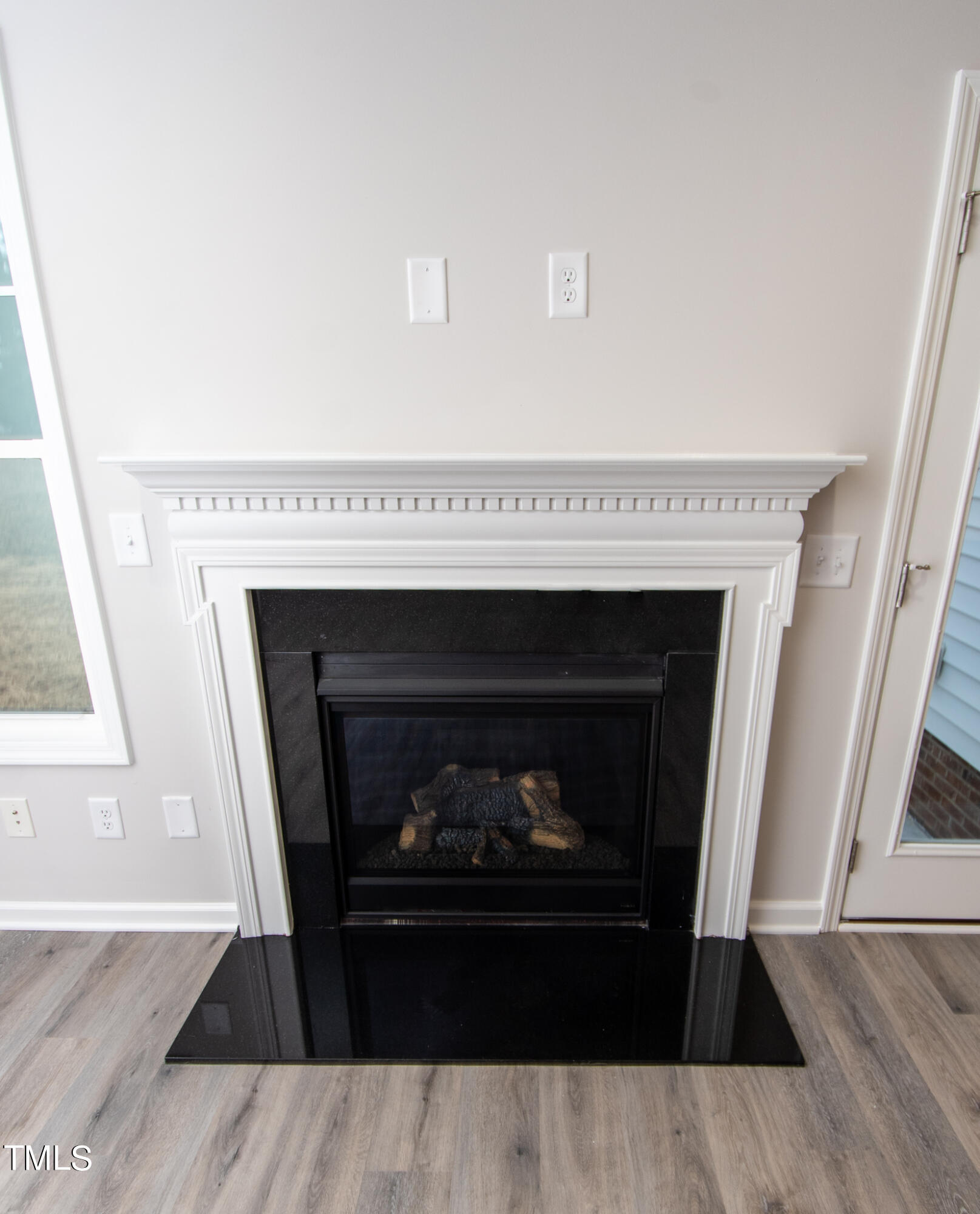 243 Waters Edge Drive Erwin, NC 28339 - Photo 7 of 53 a living room with a fireplace and a wooden floor