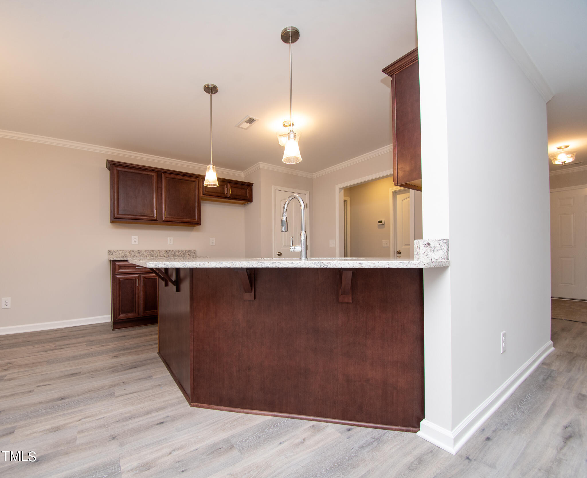 243 Waters Edge Drive Erwin, NC 28339 - Photo 9 of 53 a kitchen with kitchen island granite countertop a stove and a wooden floor