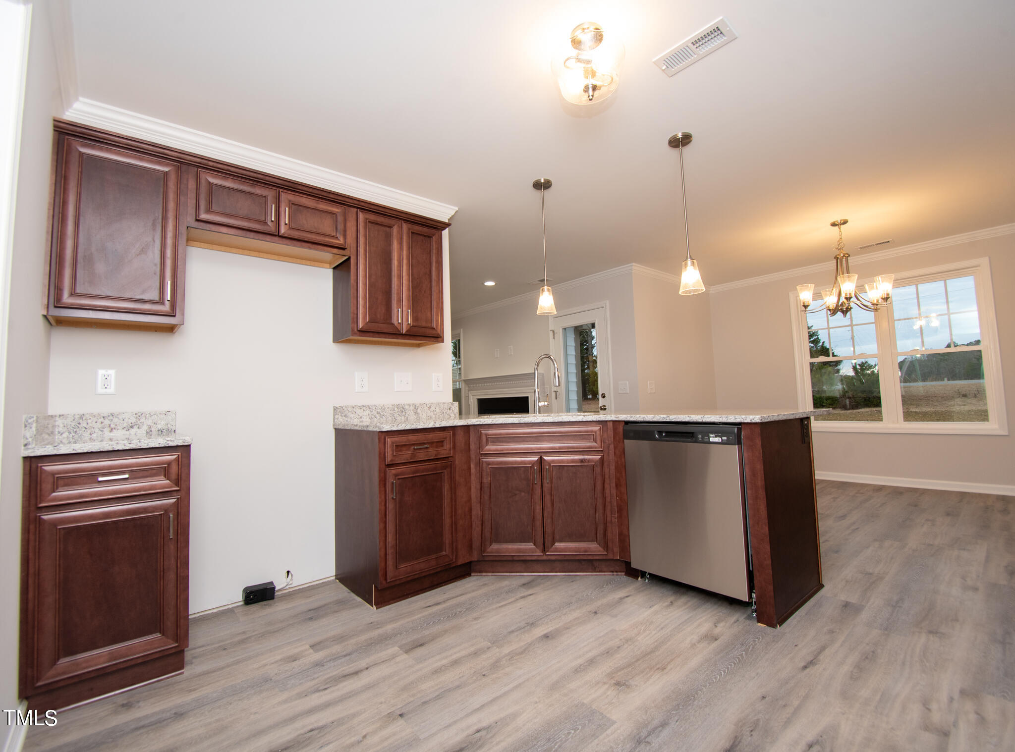 243 Waters Edge Drive Erwin, NC 28339 - Photo 10 of 53 a kitchen with stainless steel appliances granite countertop a refrigerator a sink dishwasher a stove and a wooden floor