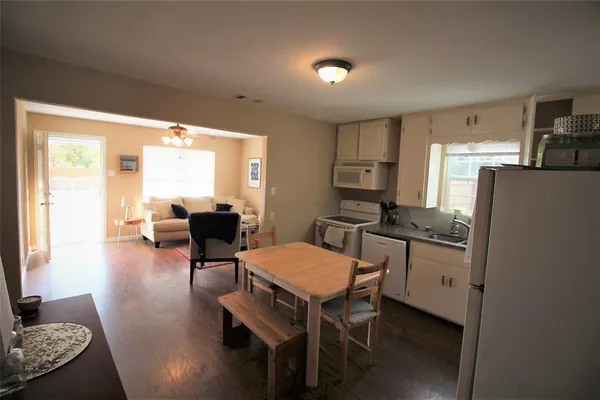 a view of a livingroom with furniture and a kitchen